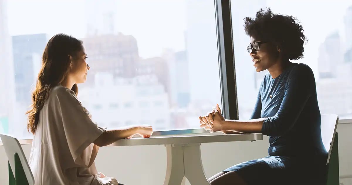 Job-interview-happening-at-table-in-front-window